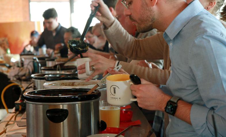 Staff line up to try samples at the Annual Chili Cook-off in Minneapolis