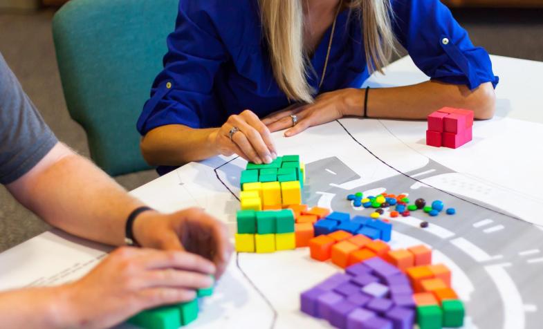 Planning charrette table with various color blocks on architectural drawing